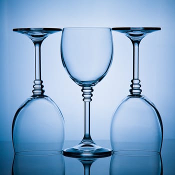 blue toned shot of a  three wineglasses in a row