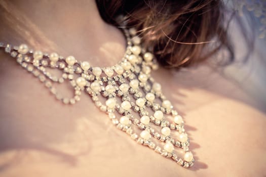 necklace from pearls on the neck of bride