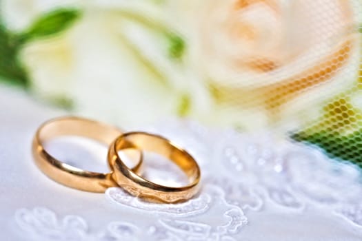 wedding rings with bouquet from roses with a shallow DOF