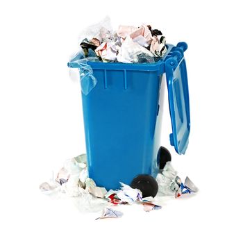 overflowing blue garbage bin on white background