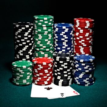 stacks of chips for poker with pair of aces