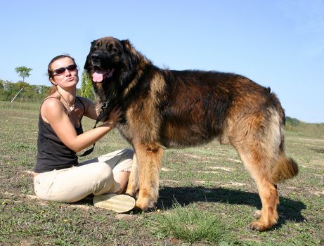 young woman and her purebred dog leonberger