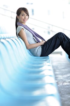 sporty girl sit in sport arena