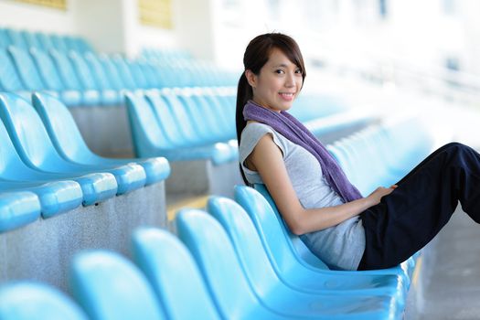 sporty girl sit in sport arena