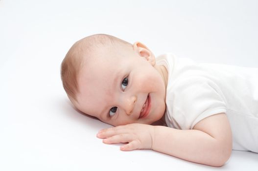smiling baby lying on the floor