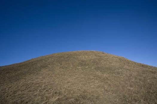 Hill towards dark blue sky