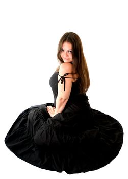 portrait of young woman in black dress sitting on the floor
