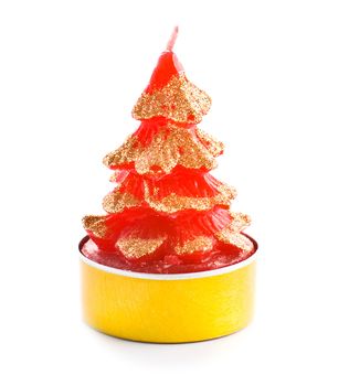 small red candle with golden sparkles in shape of christmas tree