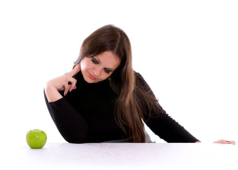 girl staring at the green apple isolated on white