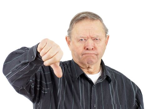 Funny face grumpy old man frowning while giving the thumbs down looking at camera, over white background.