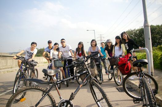 Asian friends riding bicycle