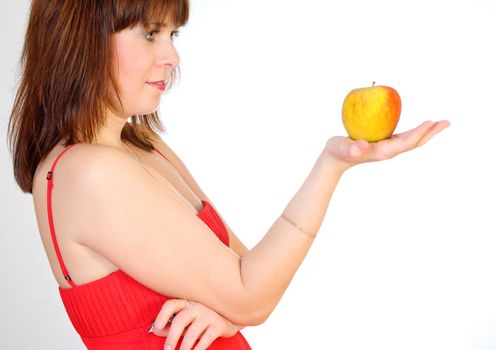 beautiful girl with apple on palm on grey background