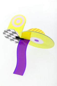 Unique art object in yellow and purple made using different geometric shapes and forms in varying colours and patterns