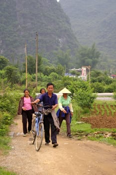 CHINA - MAY 16, Chinese villagers are going back home with his bicycle in Yangshuo, China on 16 May, 2010.