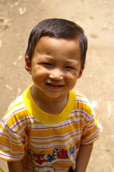 CHINA - MAY 17, A traditional Chinese young boy is smiling on Yangshuo, China on 17 May, 2010.