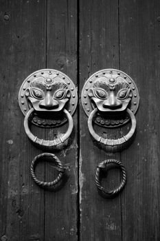 Chinese door in black and white tone, double lion knobs.