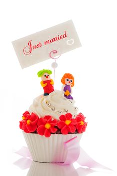 A wedding cupcake on white background as studio shot