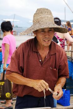 HONG KONG - SEPT 12, A traditional Chinese fisherman is making net on Lamma Island, Hong Kong on 12 September, 2009.