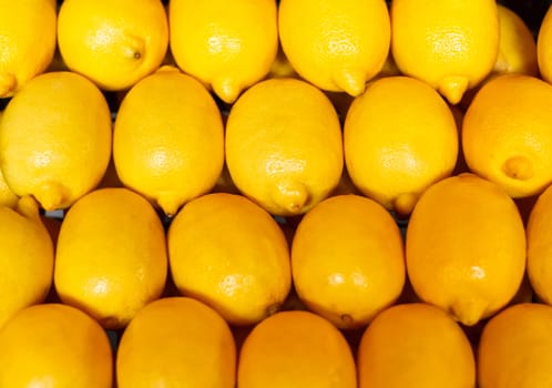 Pile of bright ripe lemons at the farmers market