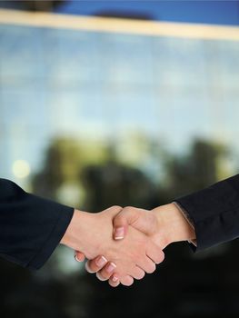 Handshake Handshaking and blured building in background