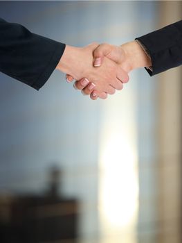 Handshake Handshaking and blured building in background