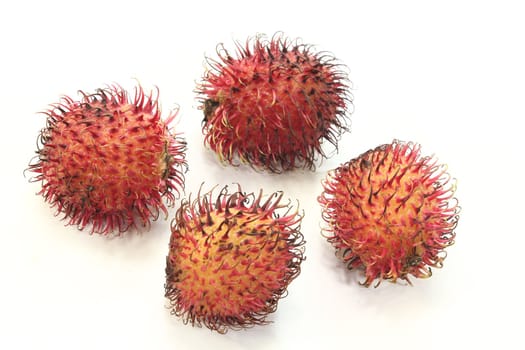 fresh red rambutan before a light background