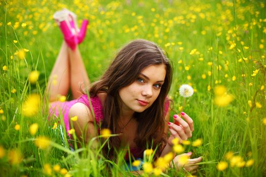 summer woman blow on dandelion 