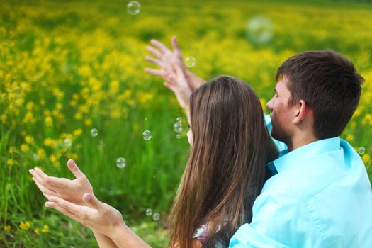 lovers hug on yellow flower field