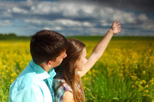 lovers hug on yellow flower field