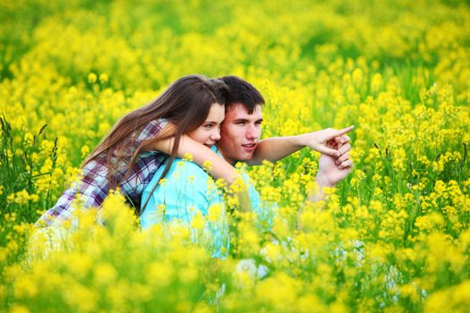 lovers hug on yellow flower field