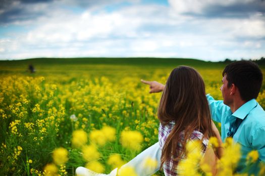 lovers hug on yellow flower field