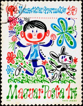 HUNGARY - CIRCA 1979: postage stamp shows crazy boy running with dog, circa 1979