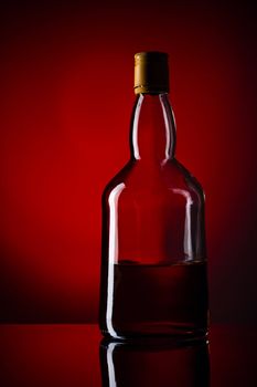 whiskey bottle, red background