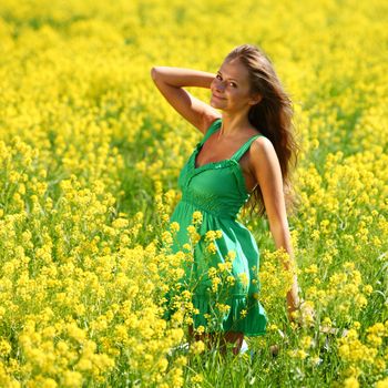 woman on oilseed field close portrait