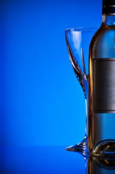 bottle of wine and glass, blue background