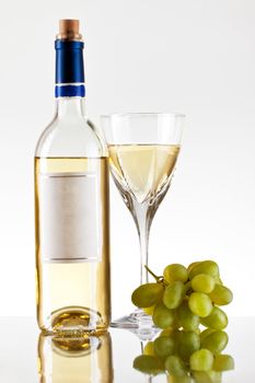 bottle and glass of wine, grape bunch, grey background