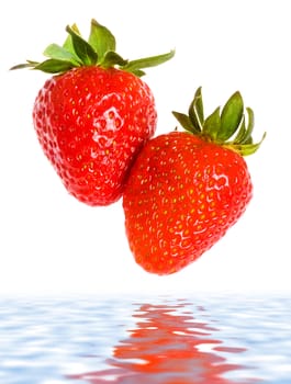 fresh ripe strawberries falling in water, white background