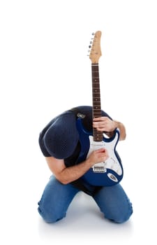 rocker playing guitar kneeling, white background