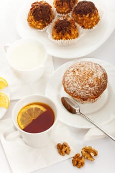 tea with fancy cakes and milk, top view