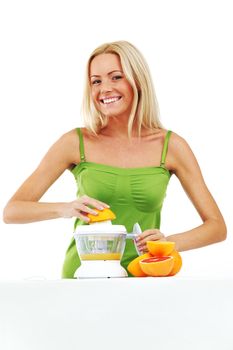 woman squeezes juice by juicer