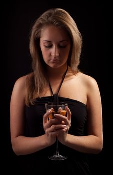 beautiful girl with glass of wine, black background