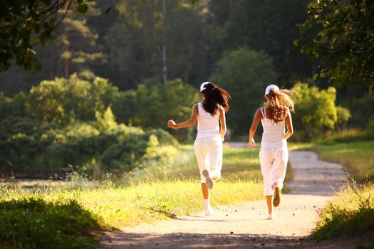 women run by sunny park alley