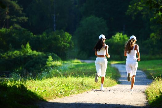 women run by sunny park alley