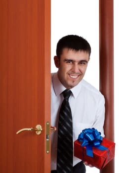 young man with gift opening the door