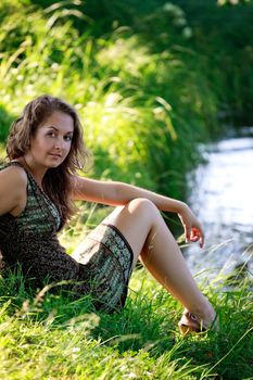 beautyful woman sitting on riverside