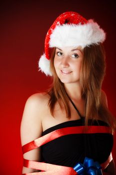 smiling girl in santa hat, red background