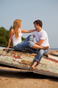 young couple sitting on old boat