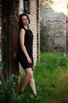 beautiful girl standing amongst ruins