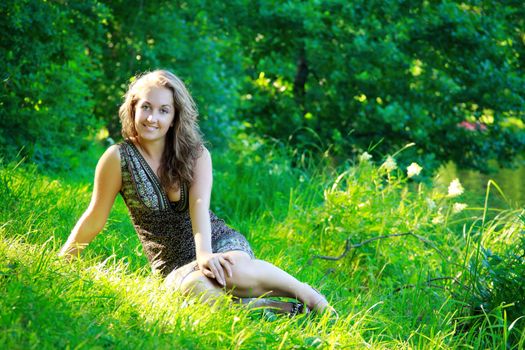 beautyful woman sitting on summer  riverside