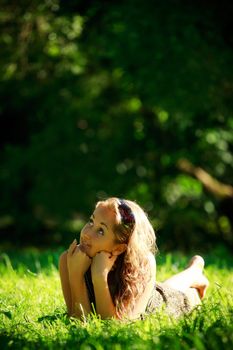 beautiful girl laying on sunny meadow